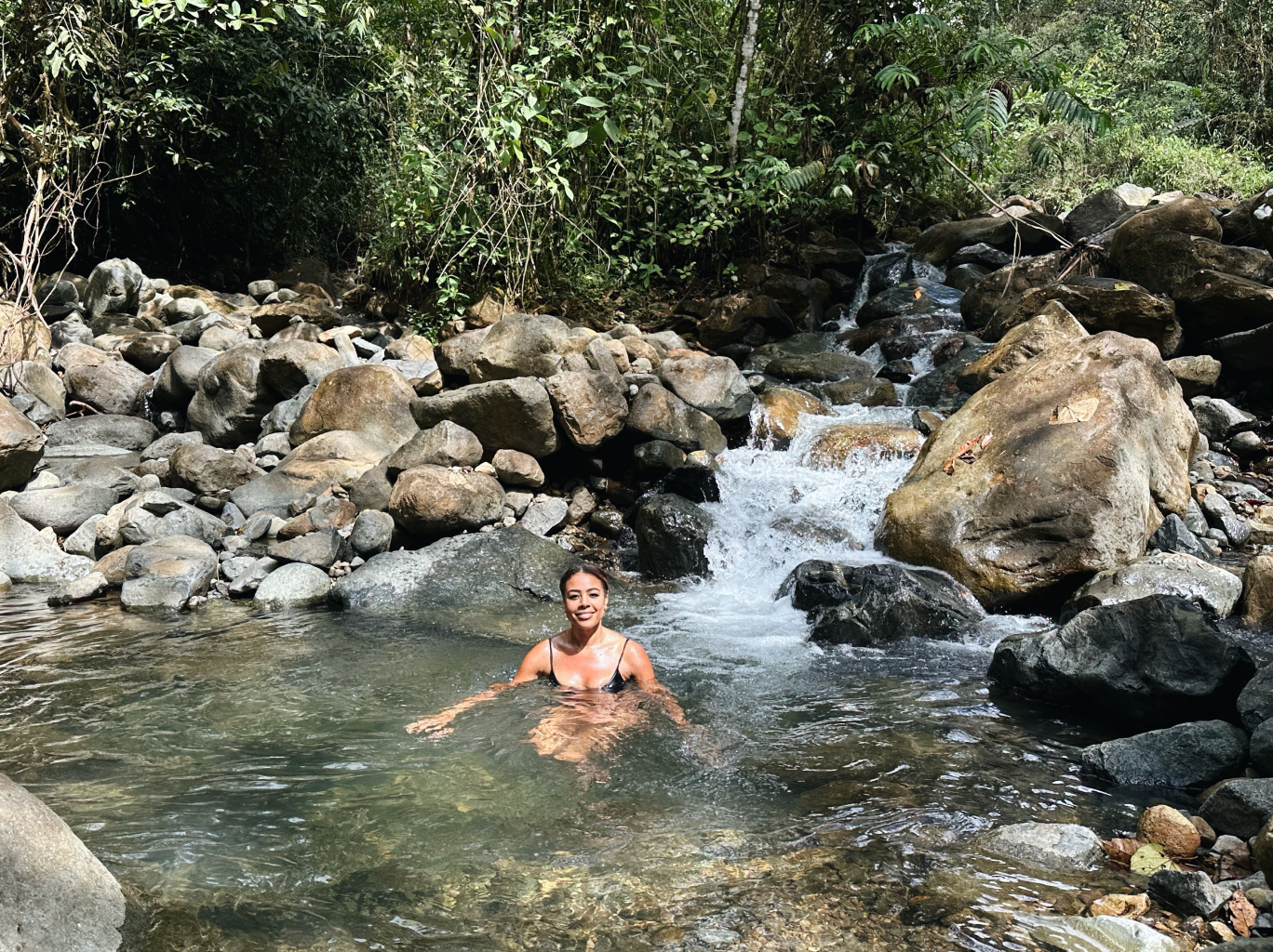 Nancy Twine in a bath carved from stone, traveling solo in Costa Rica
