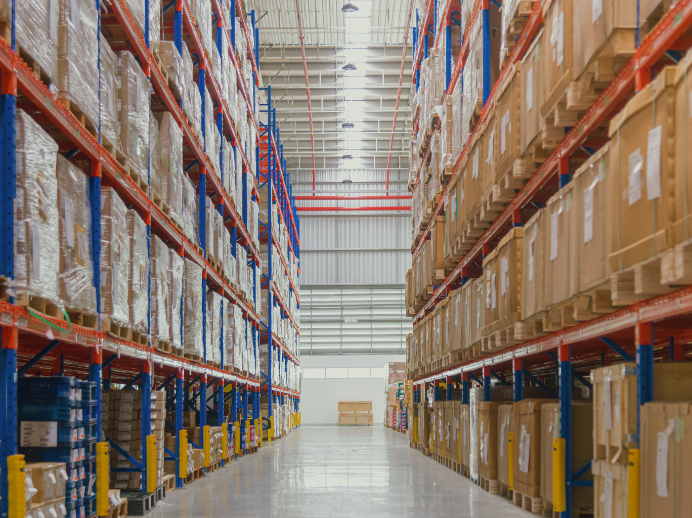The inside of a manufacturing warehouse, showcasing flawlessly arranged product rows on shelves, emphasizing the significance of strategic manufacturer selection in this dynamic environment.